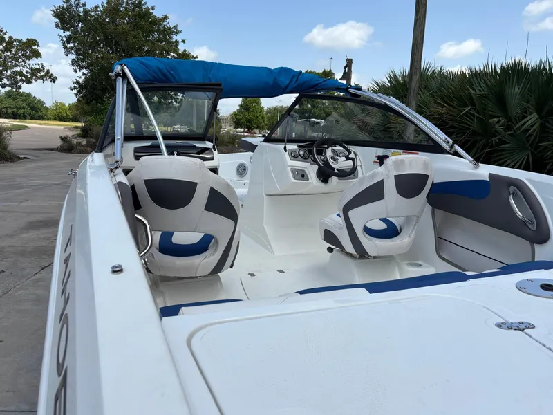 Slide: The Image of 2021 Tahoe 550TF boat interior with blue and white seating, steering wheel, and dashboard. - 10