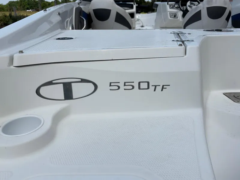 Slide: The Image of 2021 Tahoe 550TF boat interior with logo and seating area. - 11
