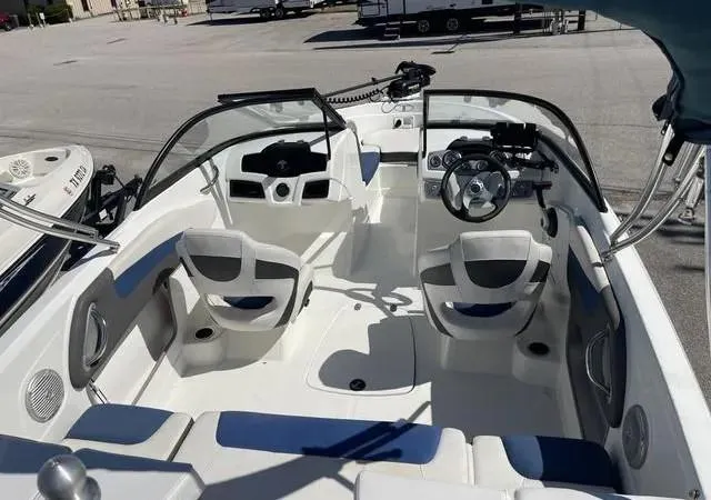 Slide: The Image of 2021 Tahoe 550TF boat interior with steering wheel and seating. - 2
