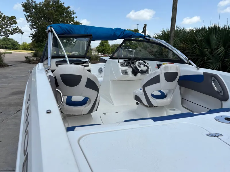 Slide: The Image of 2021 Tahoe 550TF boat interior with blue and white seating, steering wheel, and dashboard. - 3