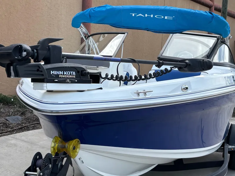 Slide: The Image of 2021 Tahoe 550TF boat with Minn Kota PowerDrive motor, blue and white design. - 8