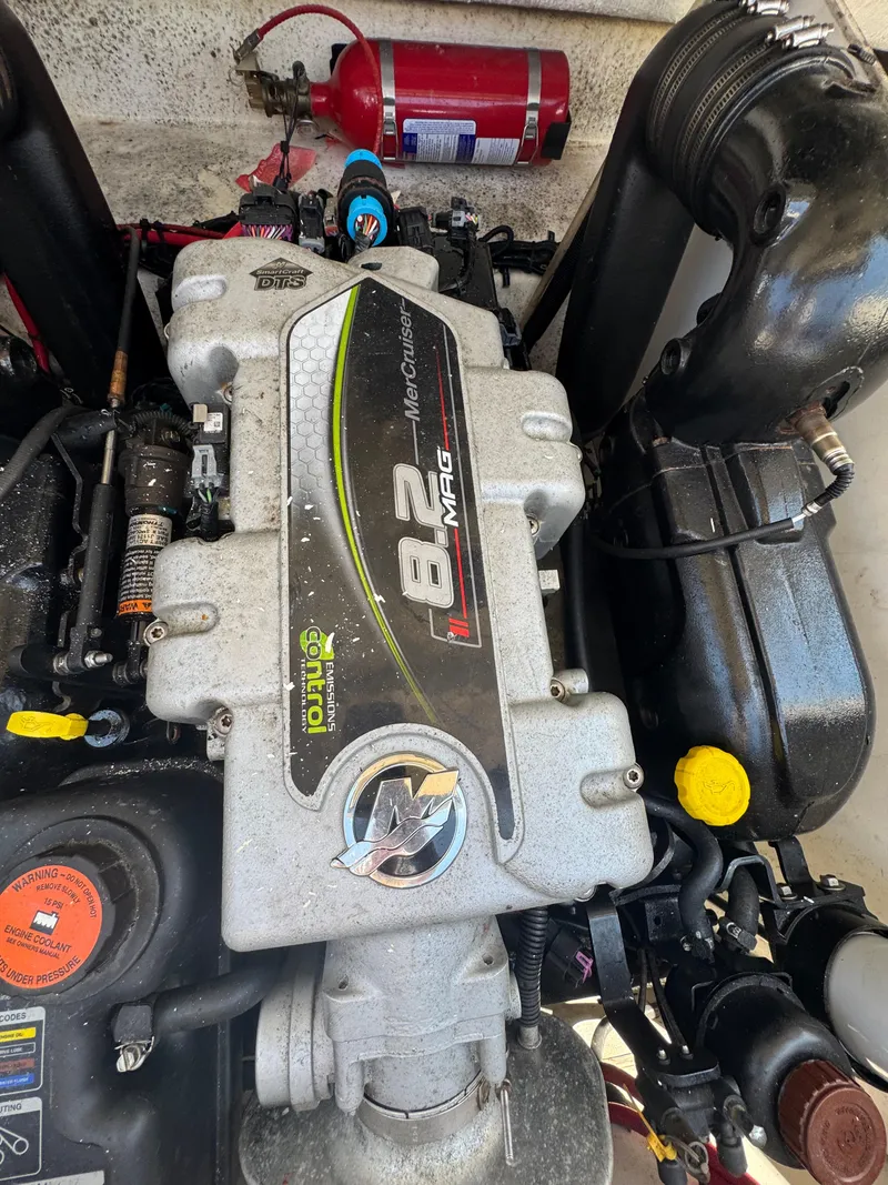 Slide: The Image of Engine of a 2015 Sea Ray 290 Sundeck boat with visible fire extinguisher. - 23