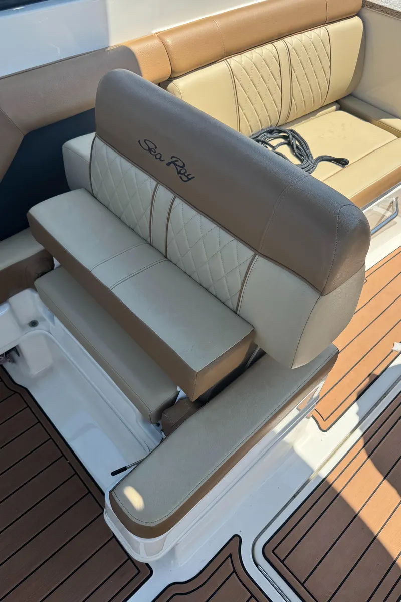 Slide: The Image of 2015 Sea Ray 290 Sundeck boat seating with tan and cream upholstery. - 25