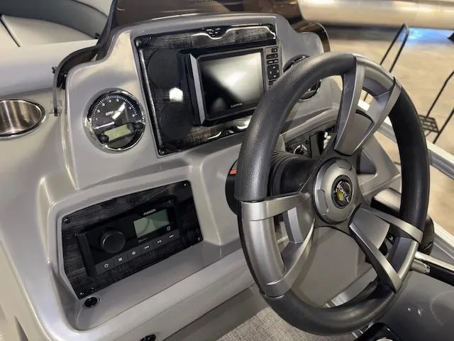 Slide: The Image of 2025 Tahoe Pontoon SLT 2180 QL dashboard with steering wheel and control panel. - 14