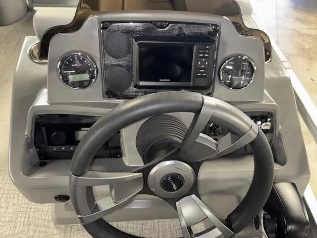Slide: The Image of 2025 Tahoe Pontoon SLT 2180 QL dashboard with steering wheel and navigation system. - 15