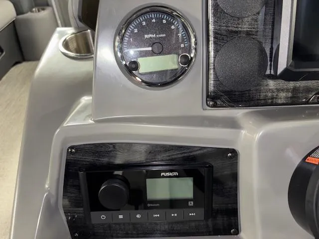 Slide: The Image of Dashboard of 2025 Tahoe Pontoon SLT 2180 QL with RPM gauge and Fusion audio system. - 16