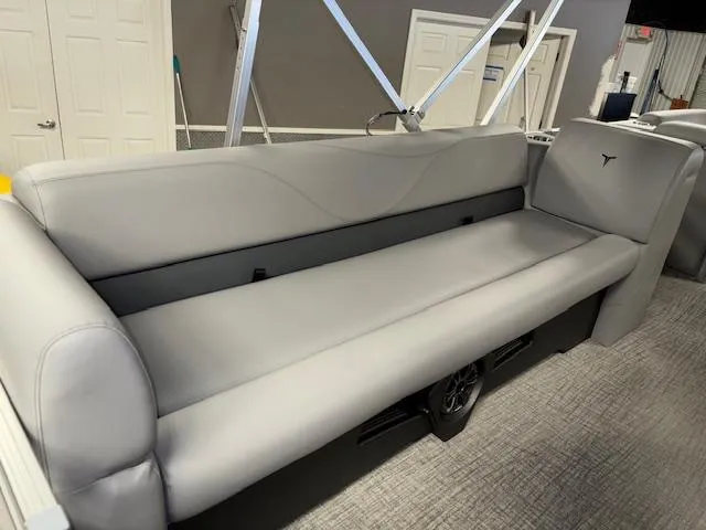 Slide: The Image of 2025 Tahoe Pontoon SLT 2180 QL with sleek gray seating in showroom. - 18