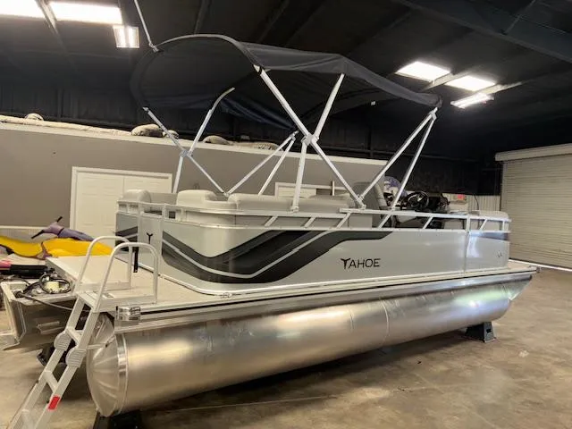 Slide: The Image of 2025 Tahoe Pontoon SLT 2180 QL in a showroom, featuring sleek design and canopy. - 6