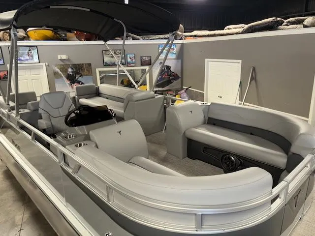 Slide: The Image of 2025 Tahoe Pontoon SLT 2180 QL with spacious seating and sleek design in showroom. - 7