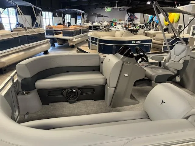 Slide: The Image of 2025 Tahoe Pontoon SLT 2180 QL interior with gray seating in showroom. - 8