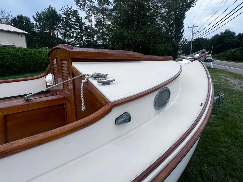 Slide: The Image of Wooden sailboat with white deck, Arey's Pond 16, 2007 model, parked near roadside. - 14