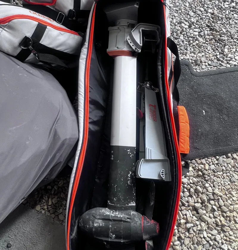 Slide: The Image of Bag containing a disassembled Arey's Pond 16 sailboat mast, model year 2007, on gravel surface. - 17