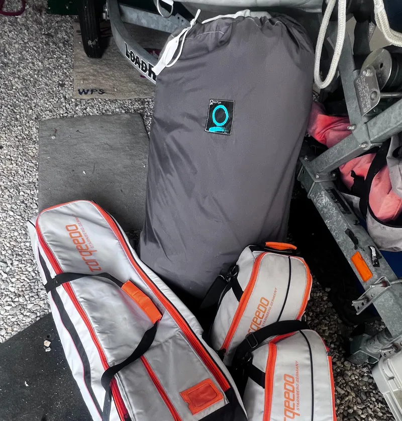 Slide: The Image of Bags and equipment stored near a trailer, featuring Torqeedo branding. - 18