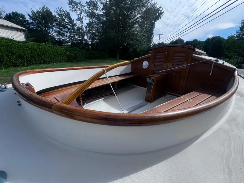 Slide: The Image of Wooden interior of a 2007 Arey's Pond 16 sailboat, featuring polished woodwork and seating. - 7