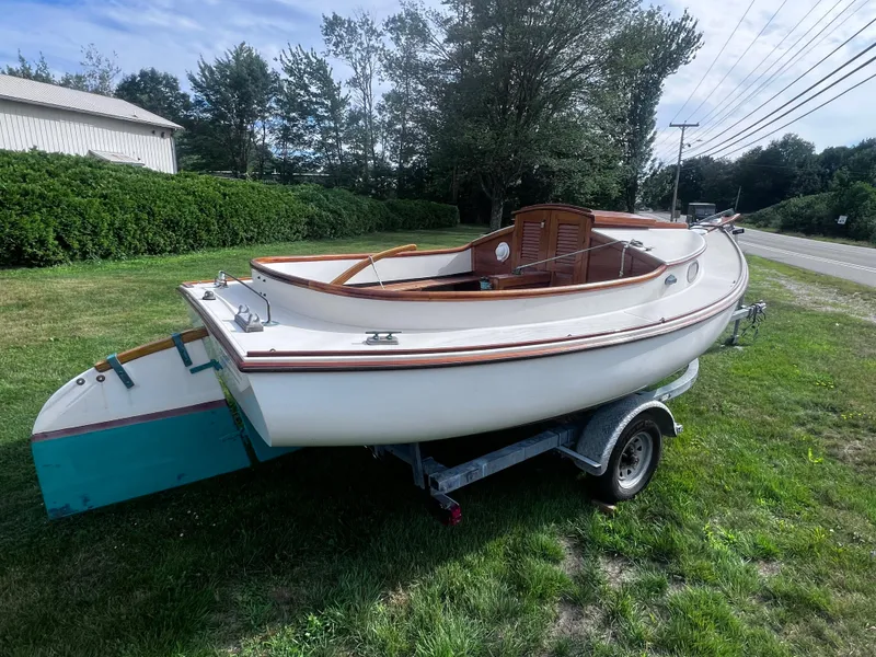 Slide: The Image of 2007 Arey's Pond 16 sailboat on trailer, parked on grassy area near road. - 8