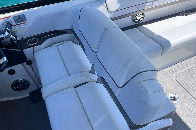 Slide: The Image of 2016 Formula 310 SS boat interior with white leather seating and modern controls. - 10