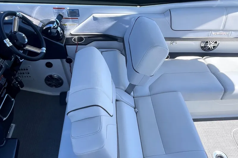 Slide: The Image of 2016 Formula 310 SS boat interior with white seating and steering wheel. - 11