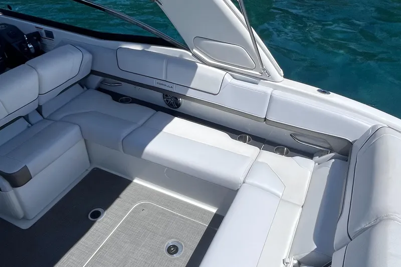 Slide: The Image of 2016 Formula 310 SS boat interior with white seating and open water view. - 12