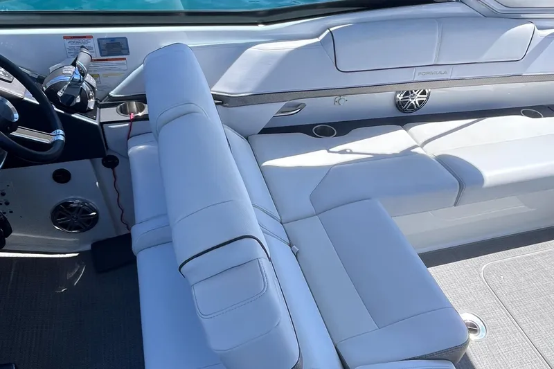 Slide: The Image of 2016 Formula 310 SS boat interior with white seating and modern dashboard. - 13