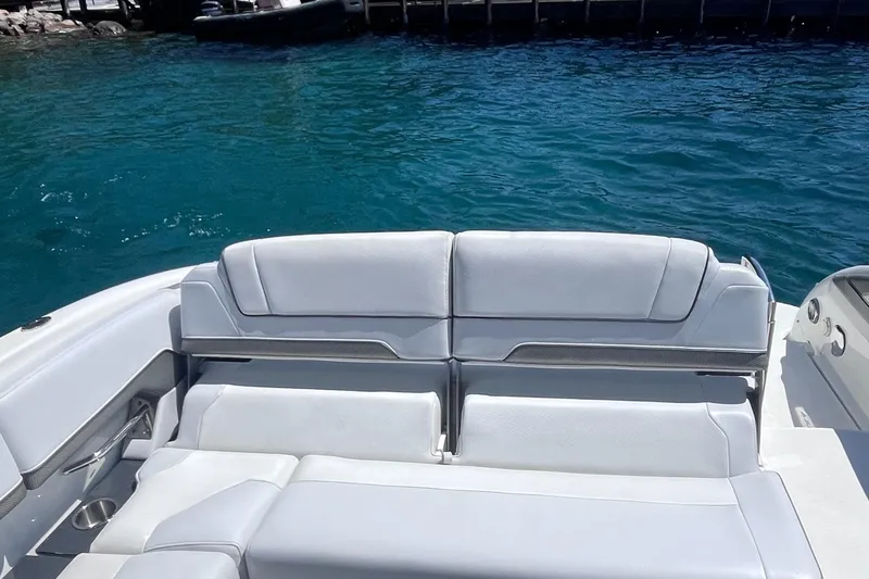 Slide: The Image of 2016 Formula 310 SS boat with white seating, docked on clear blue water. - 14