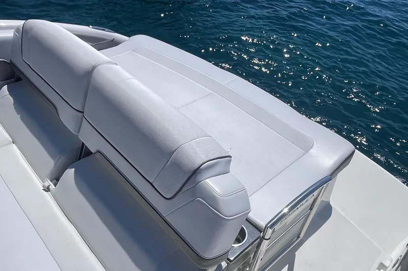 Slide: The Image of 2016 Formula 310 SS boat with sleek seating, overlooking sparkling blue water. - 15