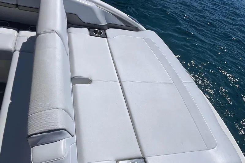 Slide: The Image of 2016 Formula 310 SS boat with white seating, near sparkling blue water. - 17