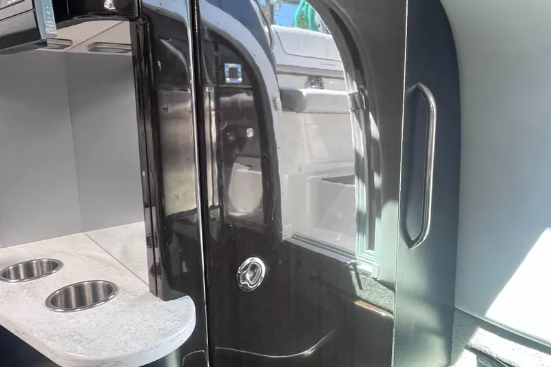 Slide: The Image of Interior of a 2016 Formula 310 SS boat, featuring sleek cabinetry and stainless steel fixtures. - 19