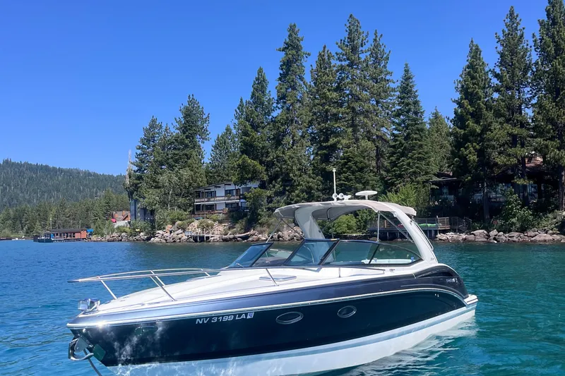Slide: The Image of 2016 Formula 310 SS boat on a clear lake with forested shoreline. - 2