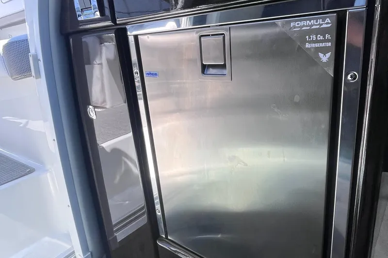 Slide: The Image of Stainless steel refrigerator in a 2016 Formula 310 SS boat interior. - 20