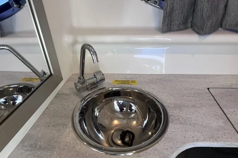 Slide: The Image of 2016 Formula 310 SS boat interior with stainless steel sink and modern faucet. - 26