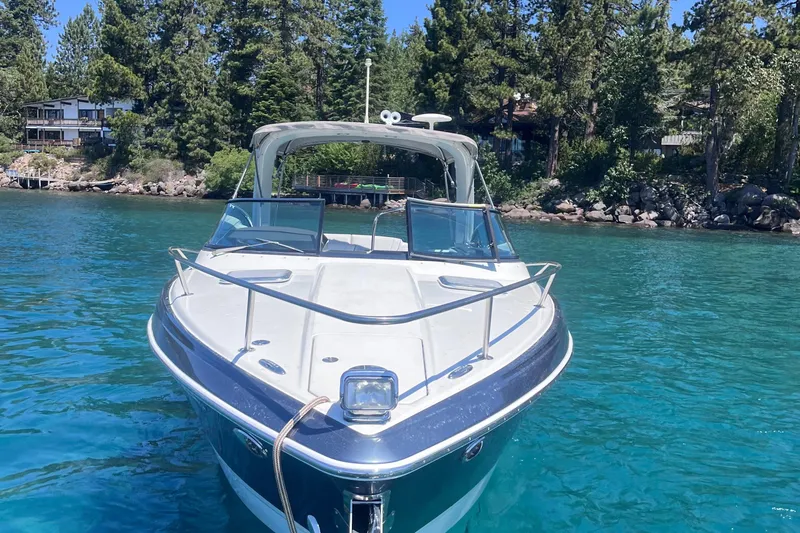 Slide: The Image of 2016 Formula 310 SS boat on clear blue water, surrounded by lush trees. - 3