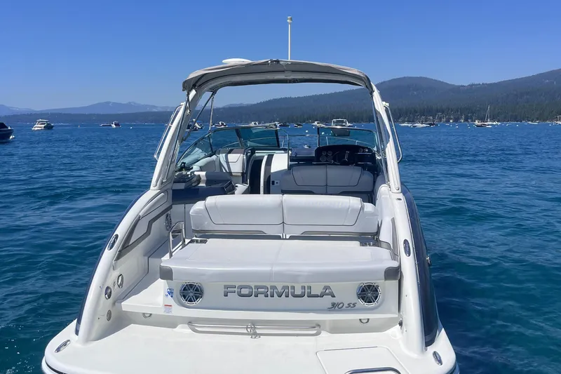 Slide: The Image of 2016 Formula 310 SS boat on a serene lake with distant mountains. - 4