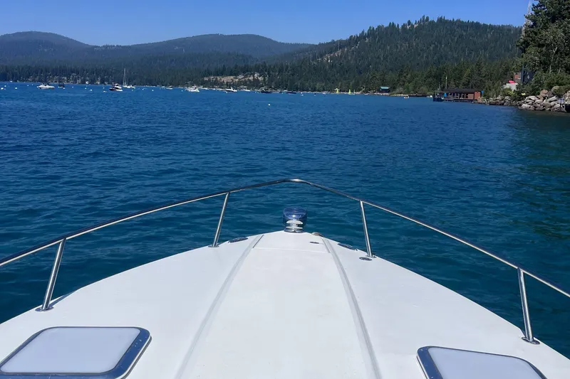 Slide: The Image of Bow of 2016 Formula 310 SS boat on a serene lake with forested hills. - 5