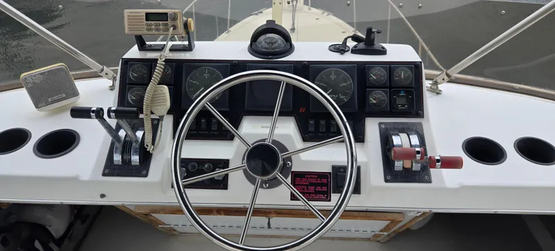 Slide: The Image of 1991 Bayliner 3288 Motoryacht helm with steering wheel and control panel. - 10