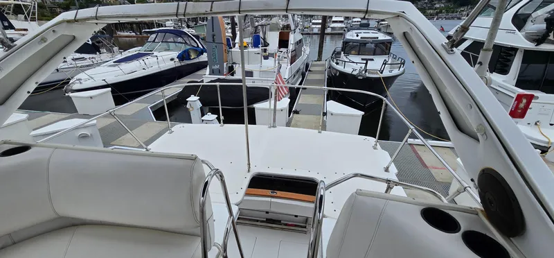 Slide: The Image of 1991 Bayliner 3288 Motoryacht docked at marina, surrounded by other boats. - 12