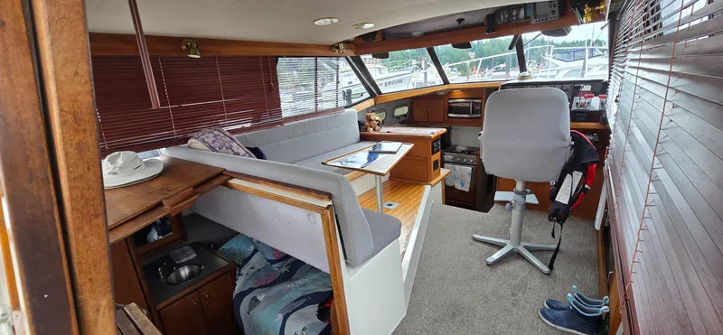 Slide: The Image of Interior of 1991 Bayliner 3288 Motoryacht with seating, helm, and kitchen area. - 13