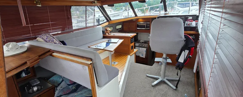 Slide: The Image of Interior of a 1991 Bayliner 3288 Motoryacht with seating, helm, and kitchen area. - 14