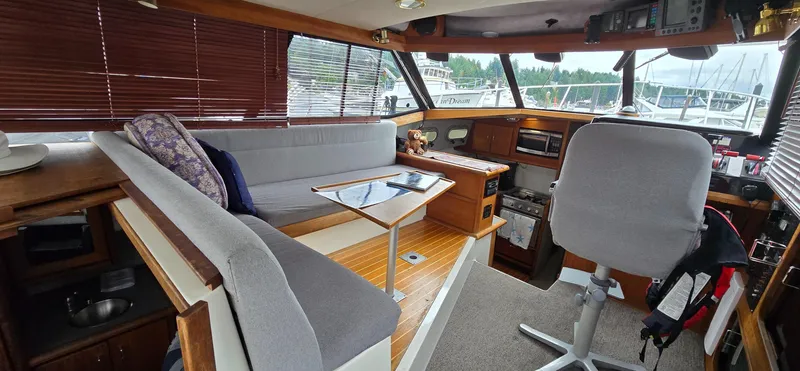 Slide: The Image of Interior of 1991 Bayliner 3288 Motoryacht with seating, table, and helm station. - 15