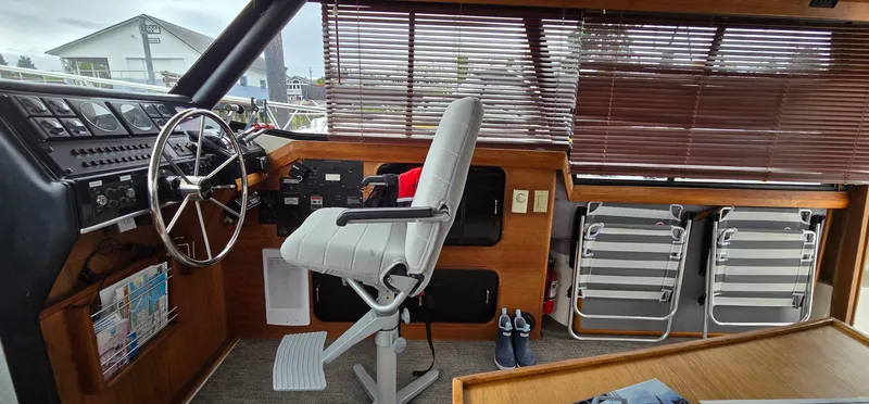 Slide: The Image of 1991 Bayliner 3288 Motoryacht helm with steering wheel, controls, and seating. - 16
