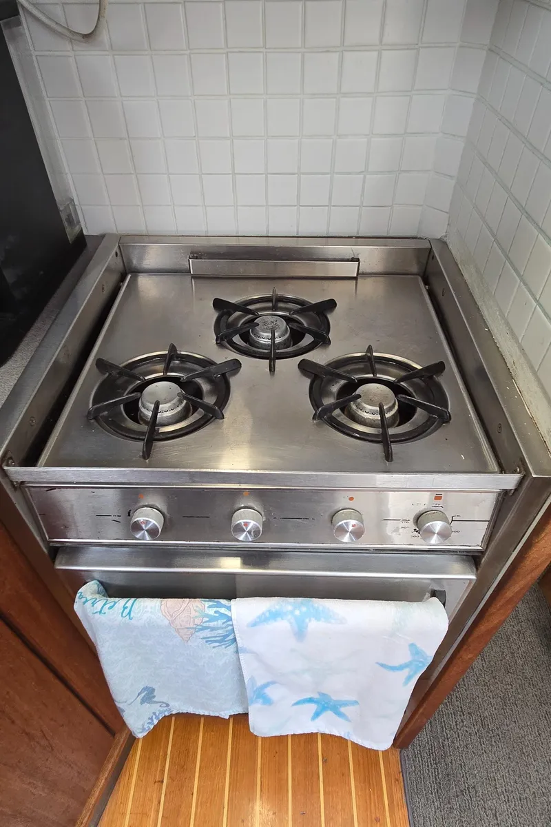 Slide: The Image of Stainless steel stove with three burners on a 1991 Bayliner 3288 Motoryacht. - 26