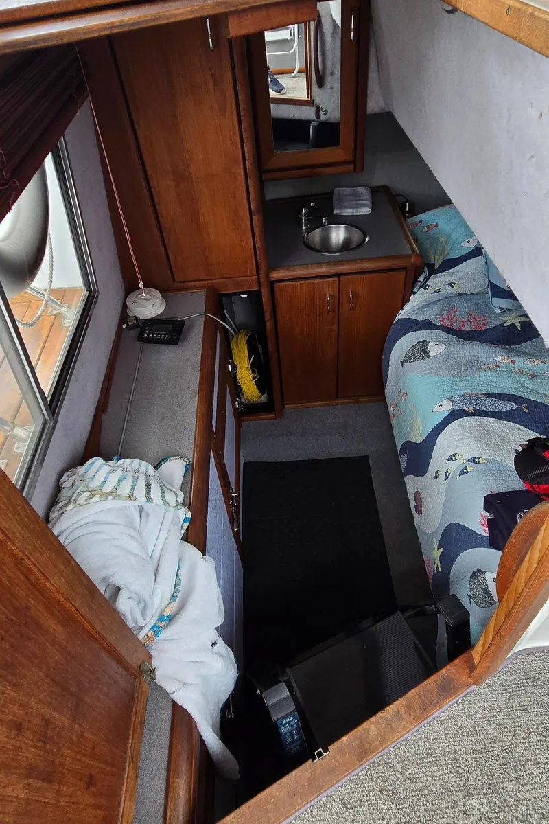 Slide: The Image of Interior of 1991 Bayliner 3288 Motoryacht with cozy cabin and compact sink area. - 29
