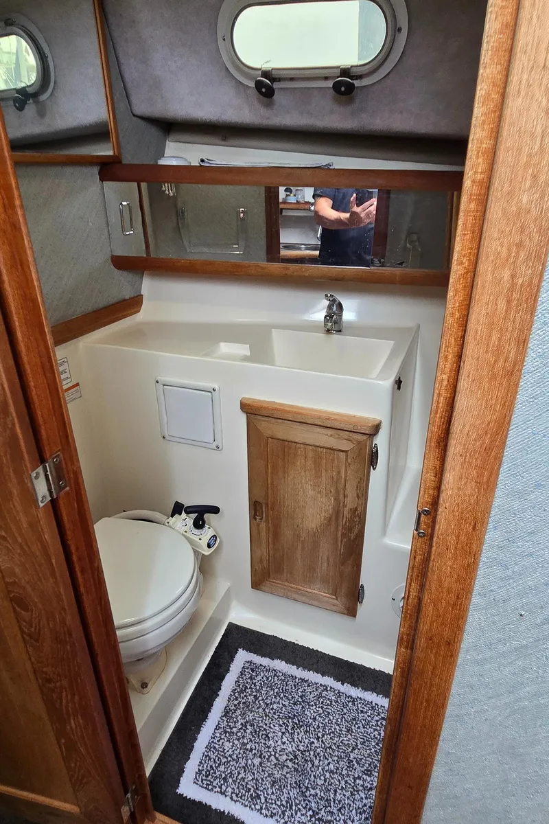 Slide: The Image of Bathroom interior of 1991 Bayliner 3288 Motoryacht with sink, toilet, and mirror. - 35