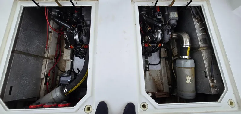 Slide: The Image of Engine compartments of a 1991 Bayliner 3288 Motoryacht, showcasing dual engines and mechanical components. - 37