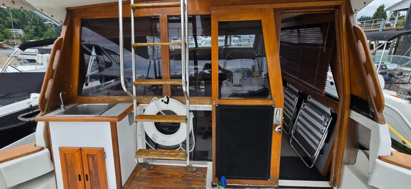 Slide: The Image of 1991 Bayliner 3288 Motoryacht with wooden accents, outdoor sink, and ladder access. - 8