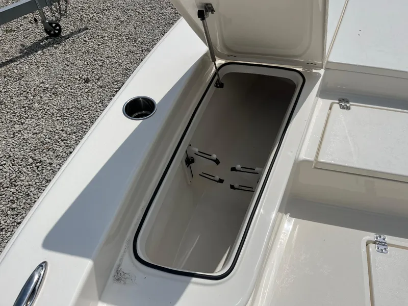 Slide: The Image of Open storage compartment on 2026 Avenger AV26 boat, featuring a sleek white interior design. - 10