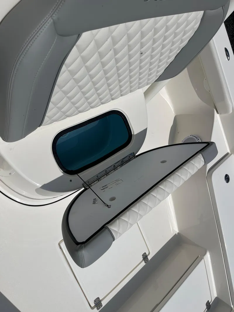 Slide: The Image of 2026 Avenger AV26 boat interior with quilted seating and storage compartment. - 14