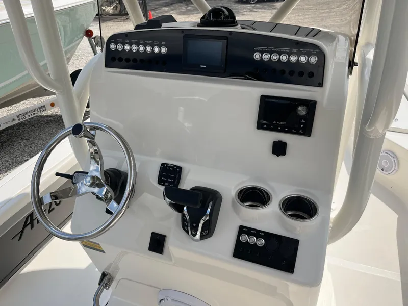 Slide: The Image of Control panel of 2026 Avenger AV26 boat with steering wheel and electronic displays. - 17