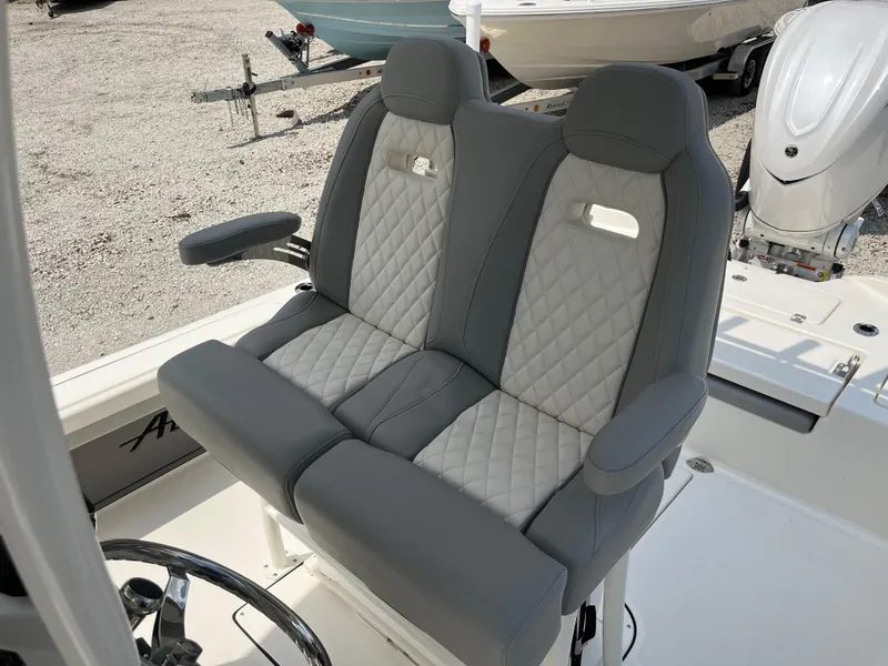 Slide: The Image of Luxury seating on 2026 Avenger AV26 boat, featuring quilted upholstery and armrests. - 21