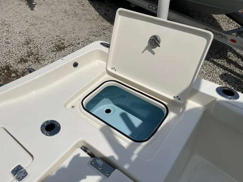 Slide: The Image of Open storage compartment on 2026 Avenger AV26 boat, showing interior details. - 27