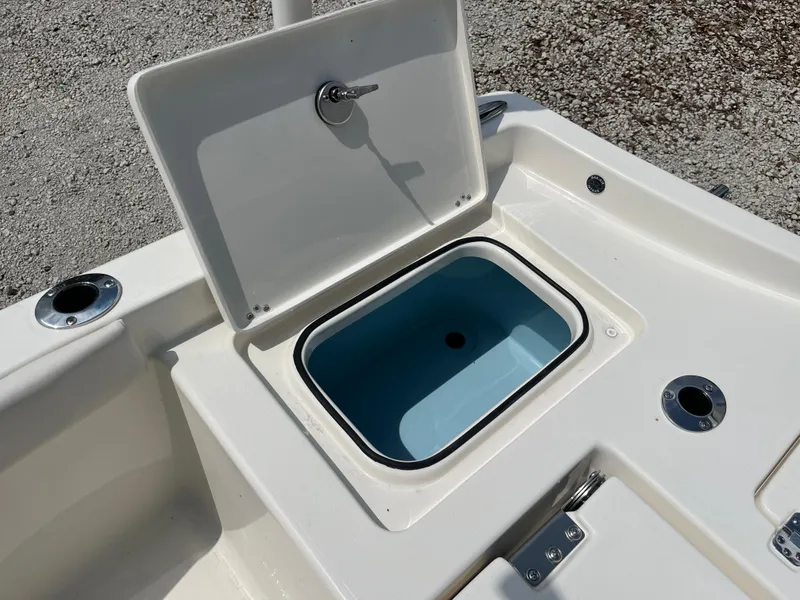 Slide: The Image of Open storage compartment on 2026 Avenger AV26 boat, featuring a blue interior. - 28